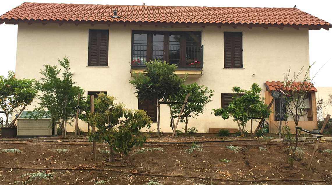 בוסתן עצי פרי בחזית הבית.